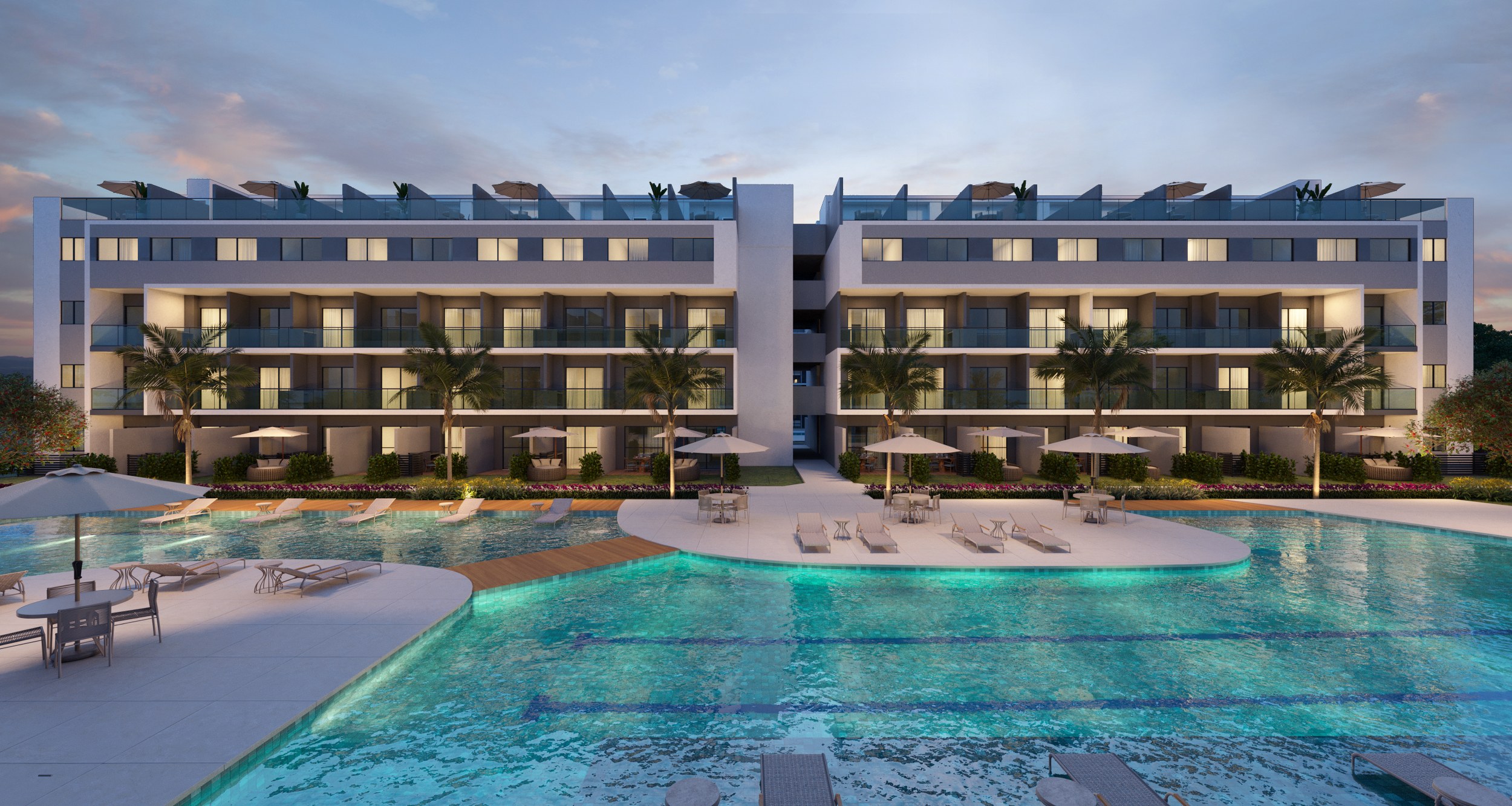 Terraços nos últimos andares coroam os blocos que se voltam para a piscina iluminada ao entardecer
