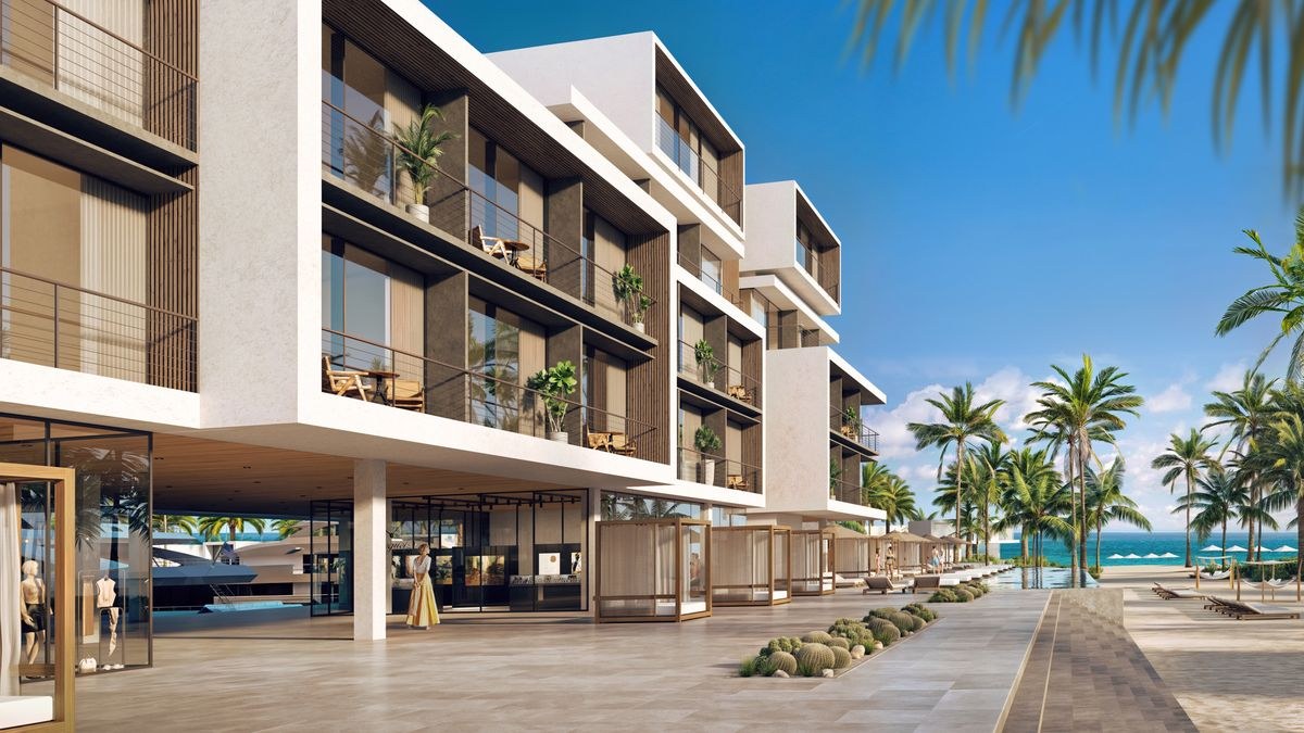 Renderização mostra edifícios com varandas e área comercial do projeto Port Nimara, em Anguilla, que une marina, resort e residências